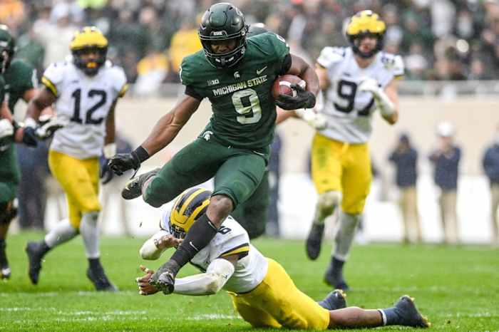 Michigan State's Kenneth Walker III avoids a tackle by Michigan's R.J. Moten during a touchdown run. Nick King/USA TODAY NETWORK / USA TODAY NETWORK